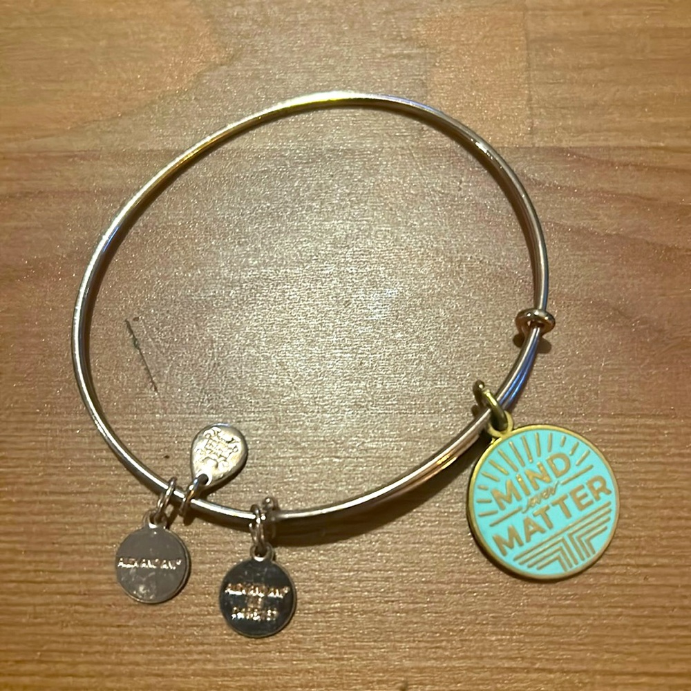 Alex and Ani copper pinch bracelet with ‘Mind Over Matter’ charm.